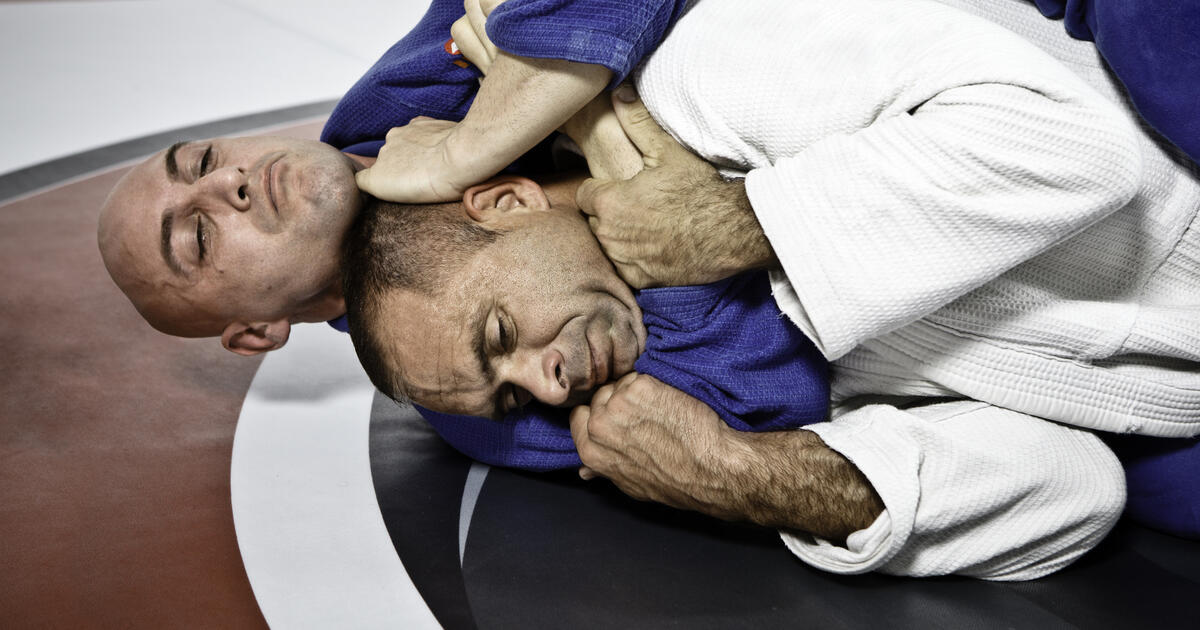 A rear naked choke  is being applied, which is a "blood" strangle and not an "air" choke.